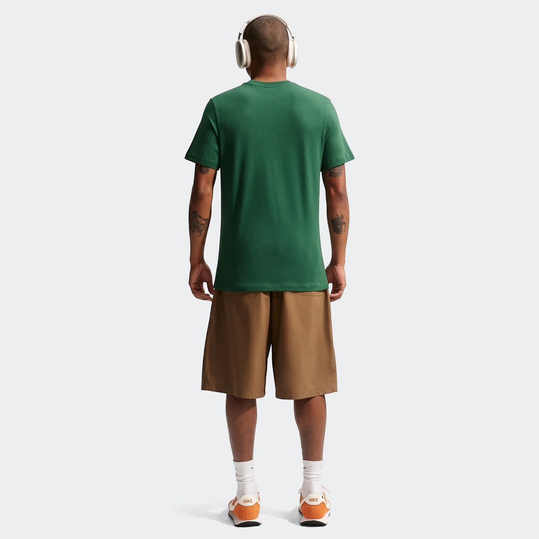 Man seen from behind wearing a 2026 Nike Springboks Rugby’S Greatest Rivalry Tour men's green t-shirt, brown shorts, and