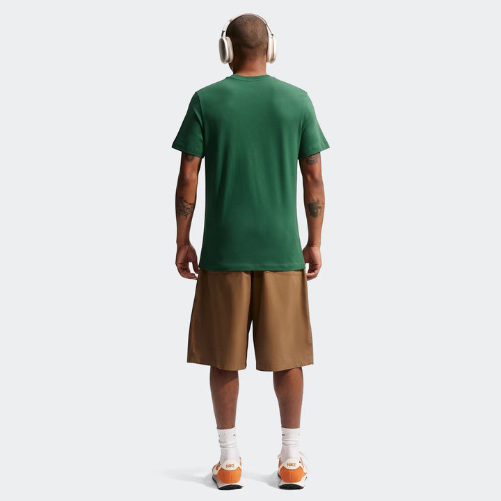 Man seen from behind wearing a 2026 Nike Springboks Rugby’S Greatest Rivalry Tour men's green t-shirt, brown shorts, and