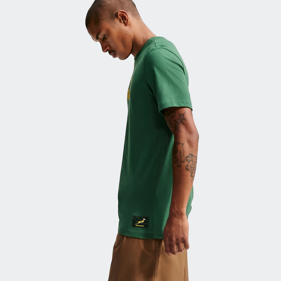 Green Nike Springboks Men's Rugby T-Shirt shown on a model in a profile view, highlighting the shirt's design and brand.