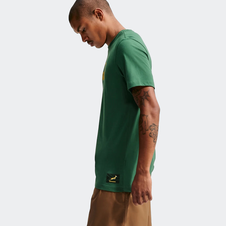 Green Nike Springboks Men's Rugby T-Shirt shown on a model in a profile view, highlighting the shirt's design and brand.
