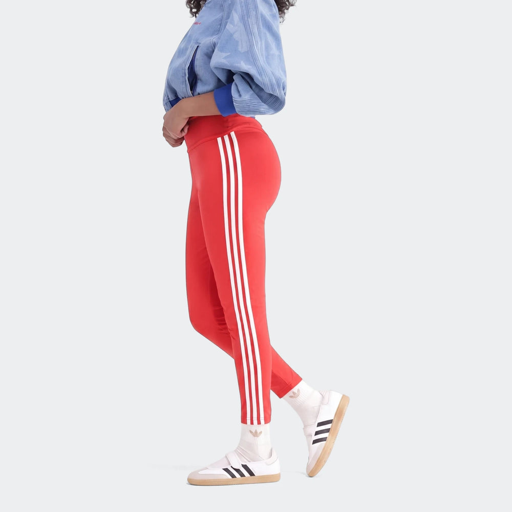 Red 3-Stripes Cotton Leggings with white stripes, worn by a model in a side view, paired with white sneakers.