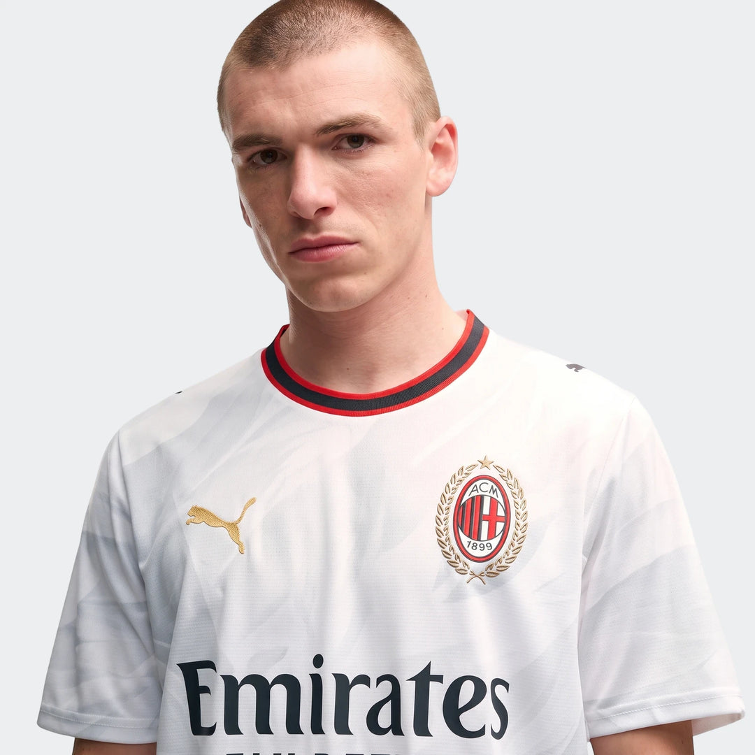 Men's AC Milan 26/27 Away Jersey in white, featuring gold Puma and AC Milan logos, and 'Emirates Fly Better' sponsor.