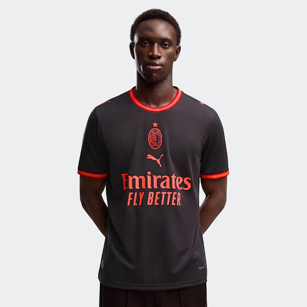 Ac Milan 26/27 Third Jersey for men in dark grey with vibrant red trim and sponsor logos, worn by a male model.