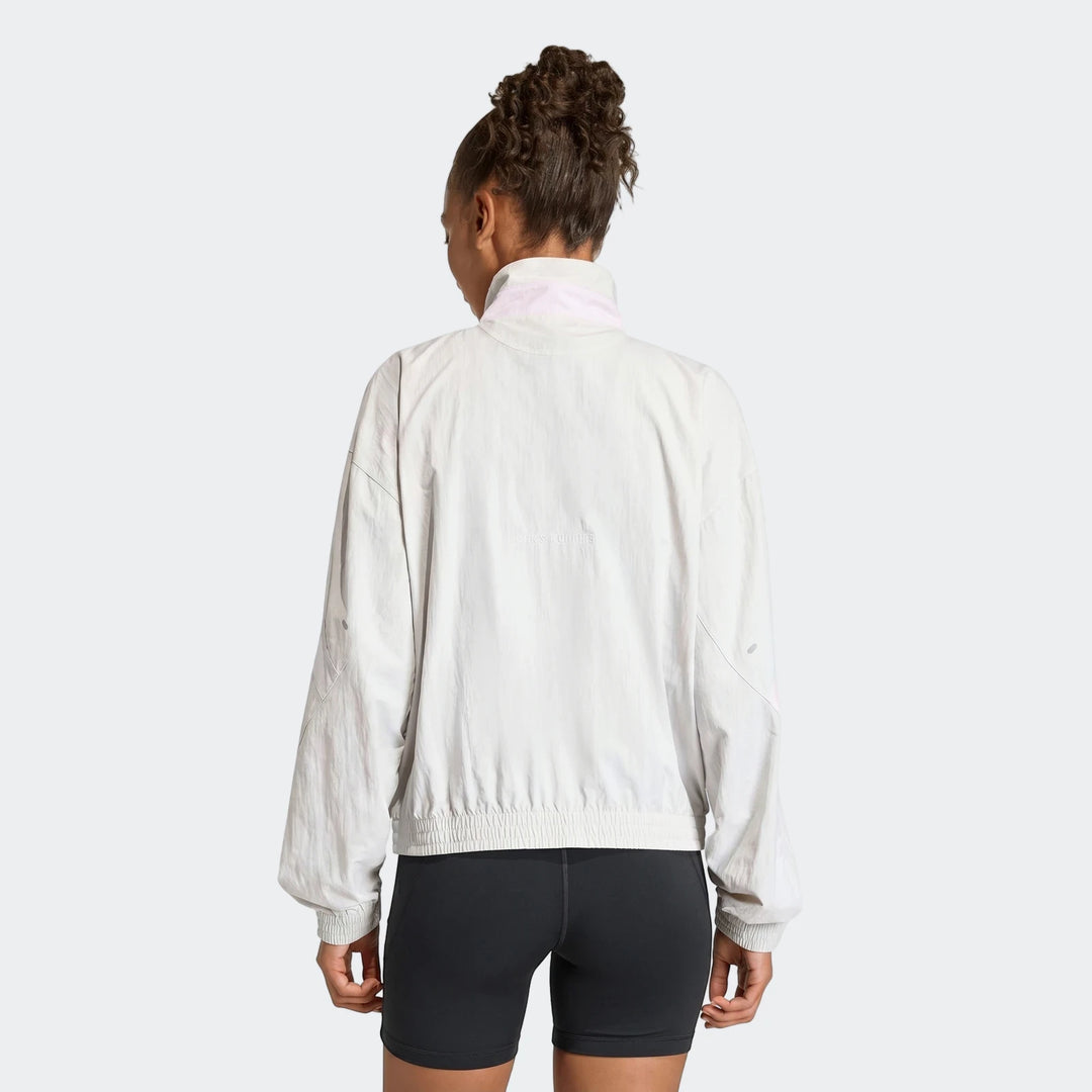Women's Adi365 Casual Jacket in light gray, shown from the back on a model wearing black shorts.