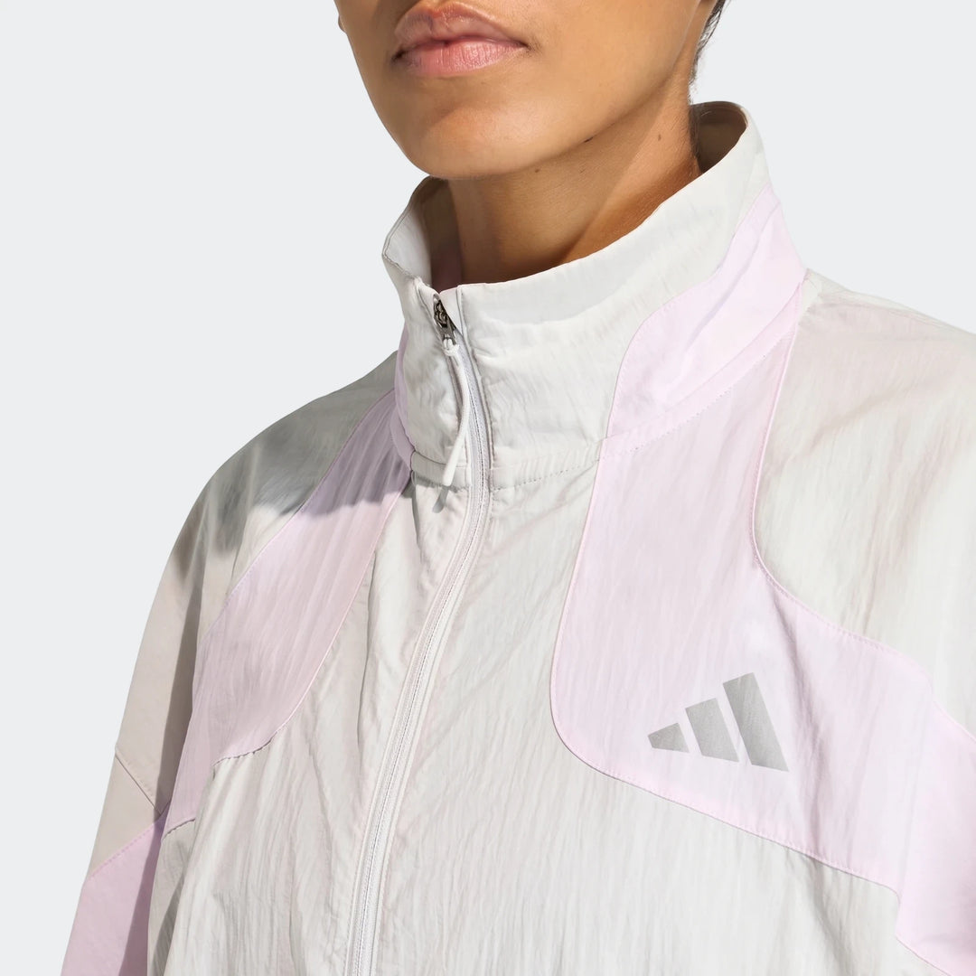 Close-up of an Adidas Adi365 Casual Jacket in light gray with pink panels, worn by a model.