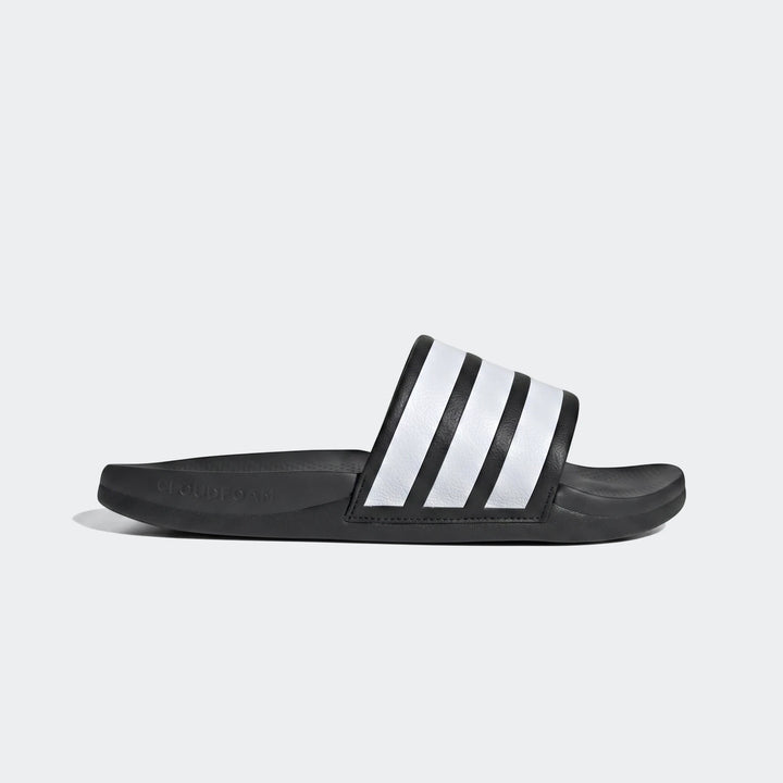Black Adidas Adilette Comfort 2.0 slides with three white stripes, shown in a side view on a plain gray background.