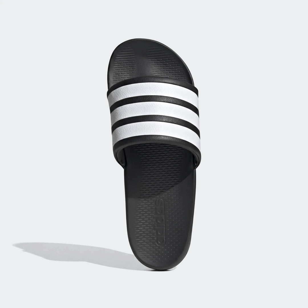 Black and white Adidas Adilette Comfort 2.0 slides with signature three stripes, viewed from above.
