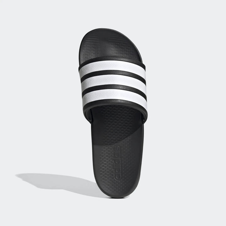 Top-down view of a black Adidas Adilette slide sandal featuring three bold white stripes across the strap. The comfortable