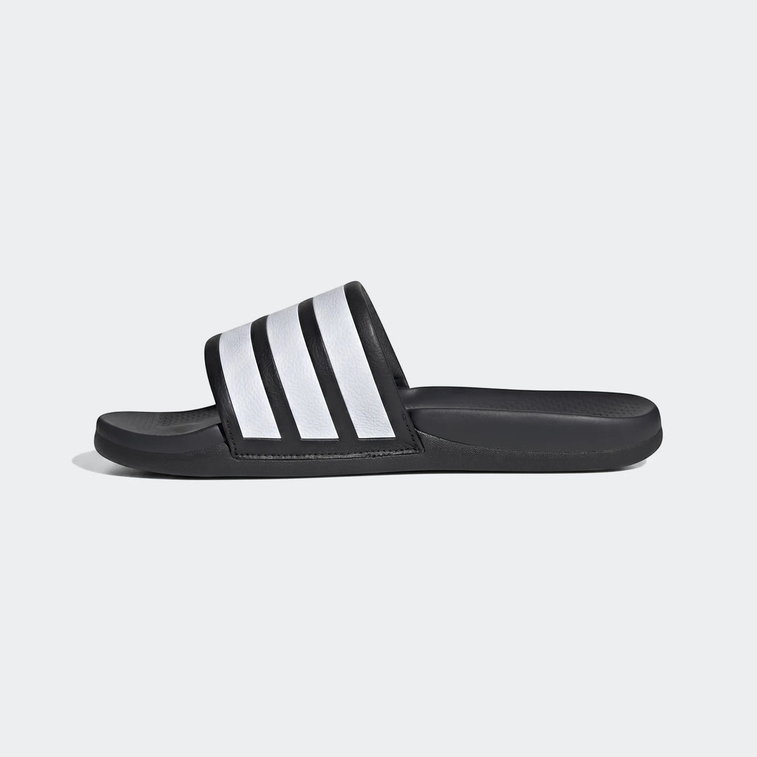 Black Adidas Adilette slide sandal with iconic white stripes, shown in a side profile view on a plain background.
