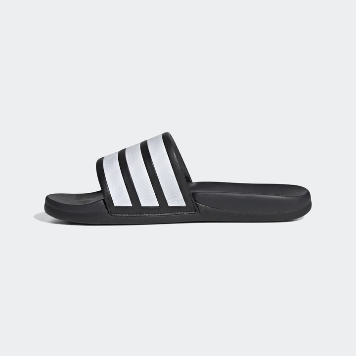 Black Adidas Adilette slide sandal with iconic white stripes, shown in a side profile view on a plain background.