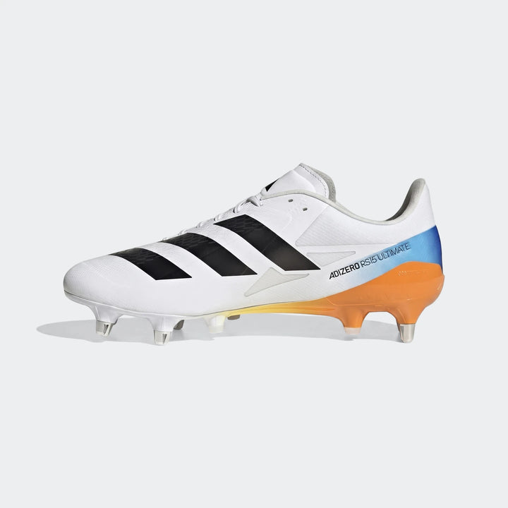 White Adidas Adizero RS15 Ultimate SG Rugby Boot with black stripes and an orange-to-blue sole, viewed from the side.