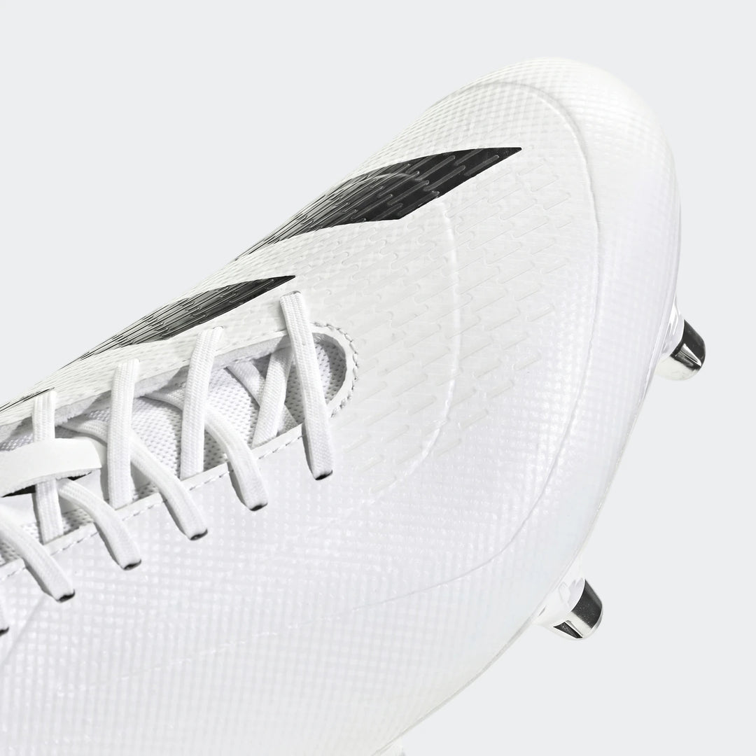 Close-up of a white Adidas Adizero Rs15 Ultimate Sg Rugby Boot, showcasing the textured upper and black Adidas stripes.