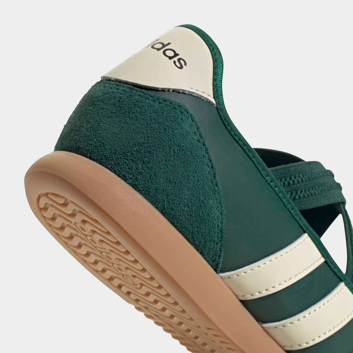 Close up of a green and cream Adidas Barreda Mary Jane shoe, showing the heel and textured tan sole.