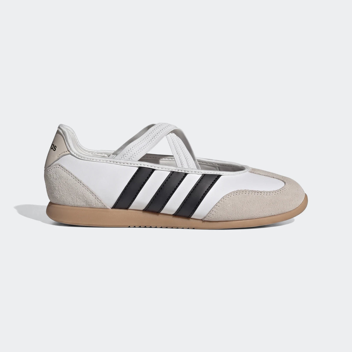 White and black Adidas Barreda Mary Jane shoes with beige suede accents and white criss-cross straps, side view.