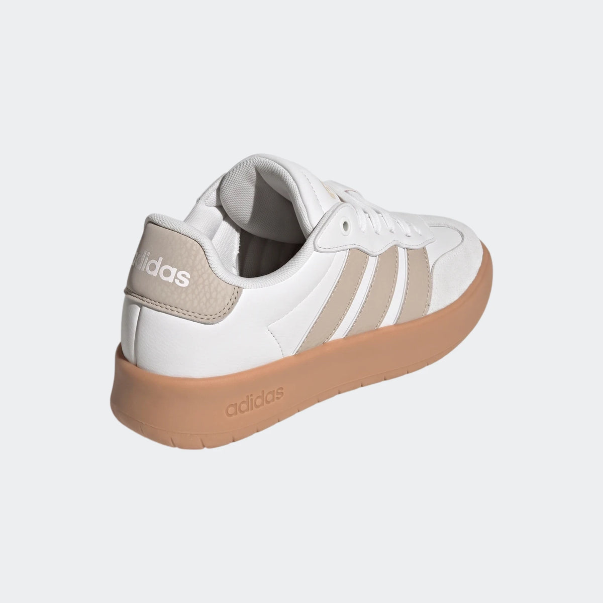 White and beige Adidas Barreda low-top sneakers with a brown sole, shown from a rear-right angled view.