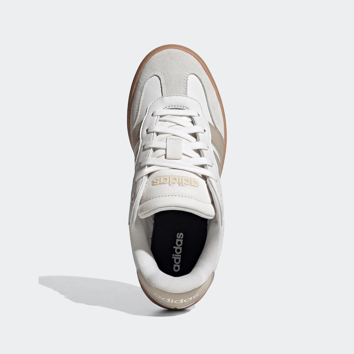 White Adidas Barreda shoes with light grey suede accents and a brown gum sole, presented in a top-down view.