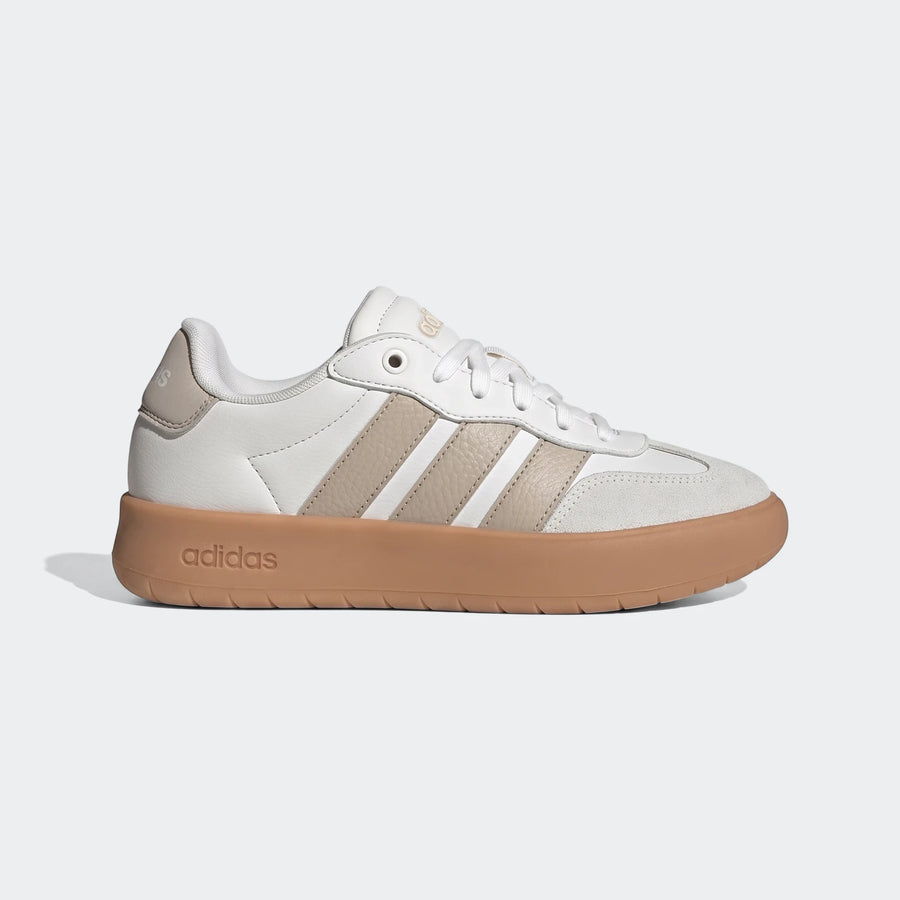 Adidas Barreda low-top sneaker in white with tan stripes and a brown gum sole, shown from a side view.