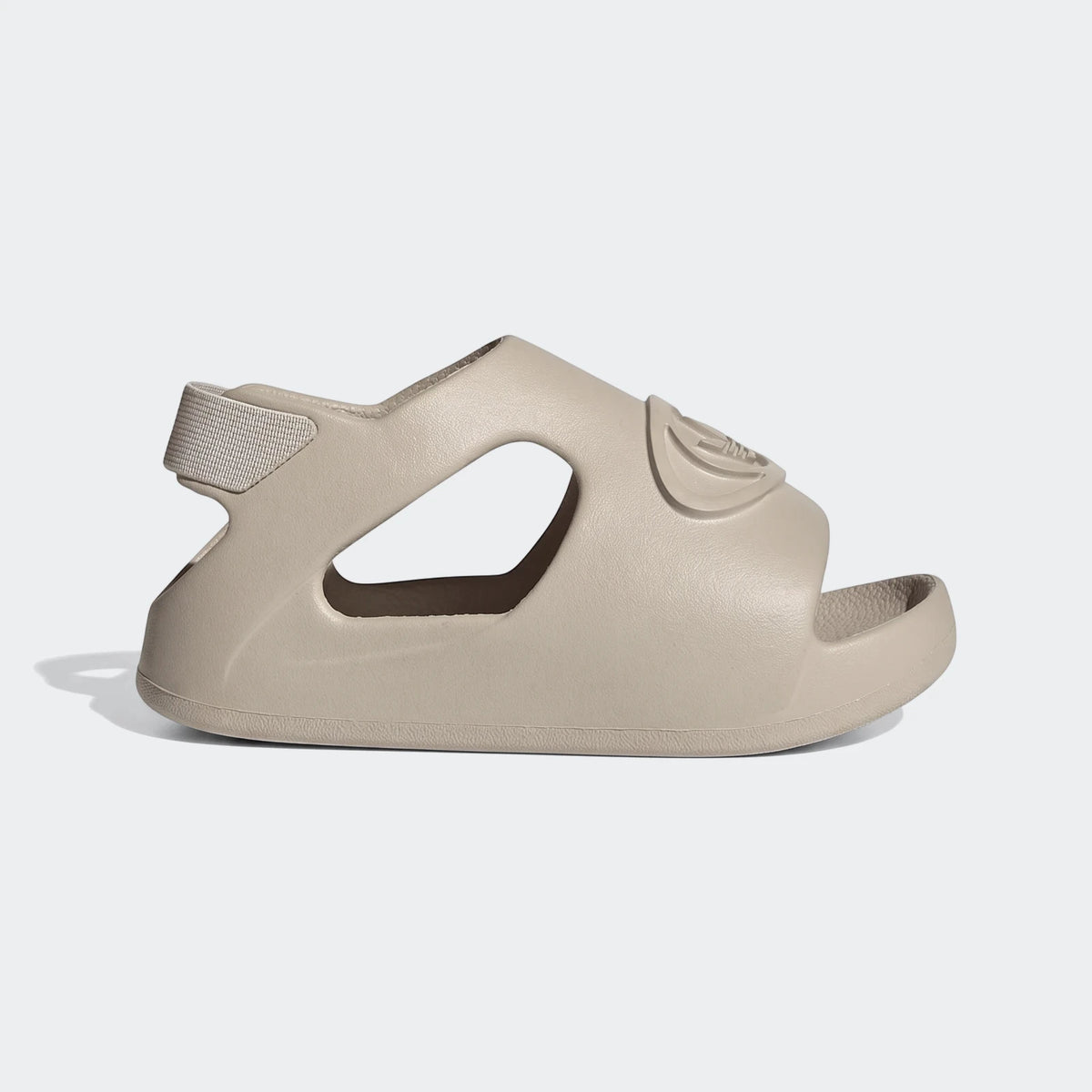 Side view of a single beige Adidas Campus 00S Foam Slide sandal, featuring a molded design and an elastic heel strap.