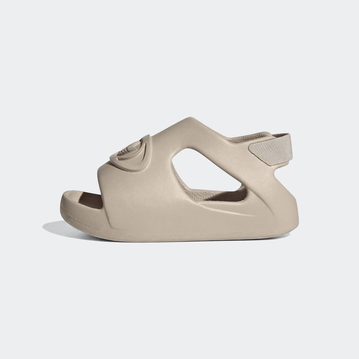 Side view of a beige Adidas Campus 00S Foam Slide, featuring a molded foam upper and a fabric strap with a logo.