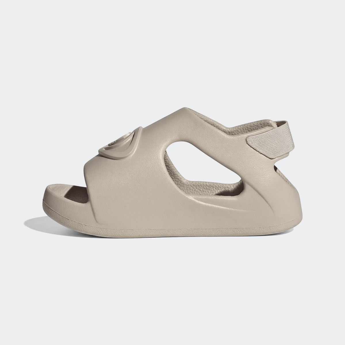 Side view of a light beige Adidas Campus 00S Foam Slide sandal, featuring a comfortable contoured design and an adjustable