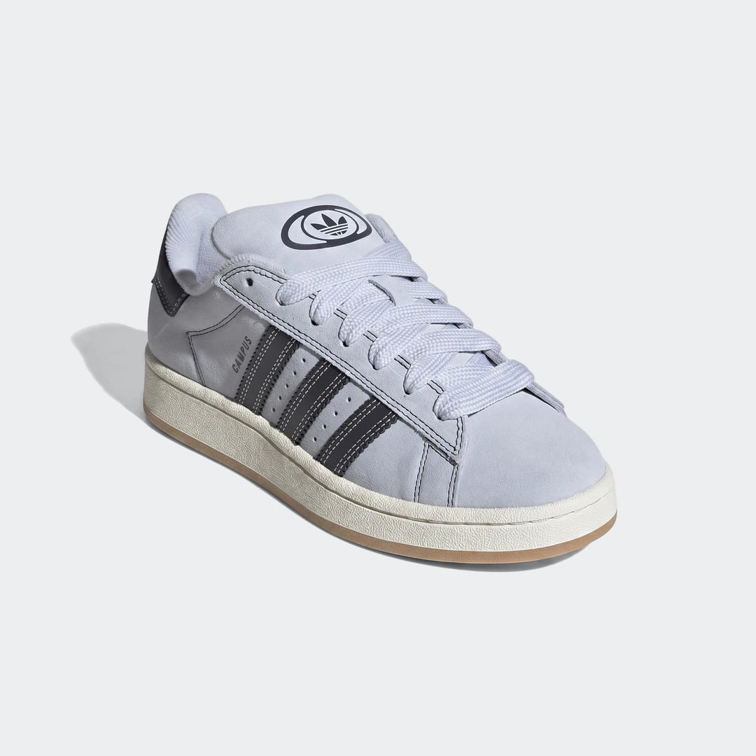 Light blue Adidas Campus 00S low-top suede sneakers, displaying the iconic three stripes and brand logo on the tongue.