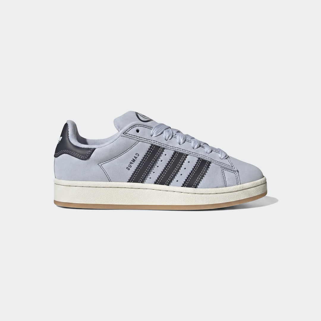 Light blue suede Adidas Campus 00S Shoes with dark stripes and an off-white sole, presented in a side profile view.