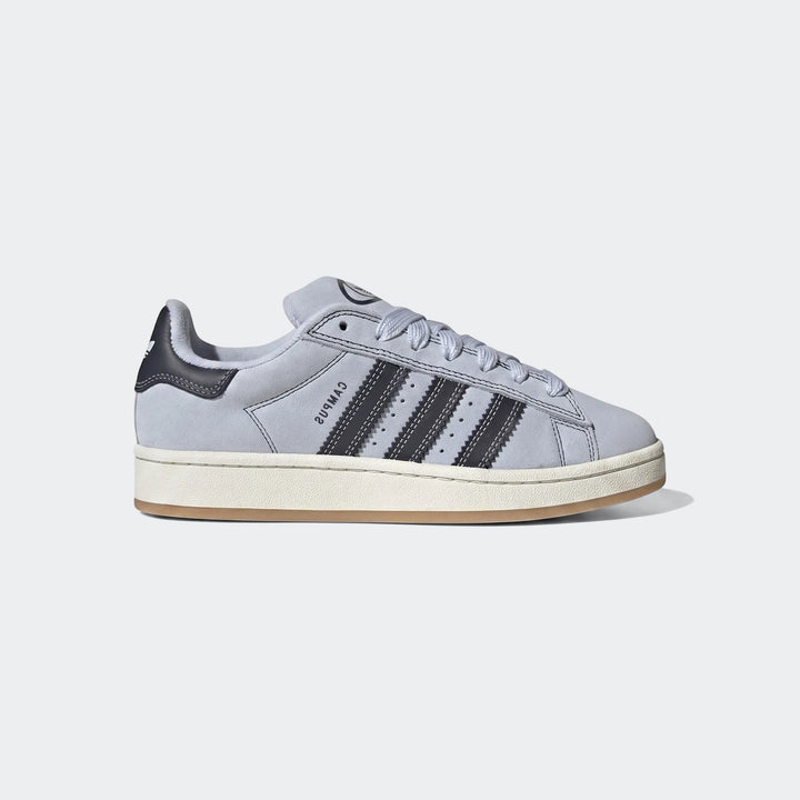 Light blue suede Adidas Campus 00S Shoes with dark stripes and an off-white sole, presented in a side profile view.