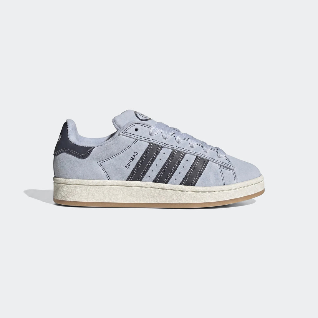 Light blue suede Adidas Campus sneaker with dark grey stripes and an off-white midsole, shown in a side profile view.