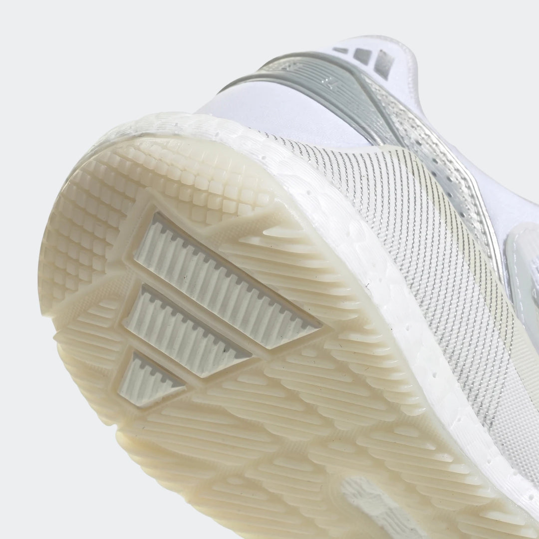 Close-up of the sole of a white and silver Adidas Crazyquick Boost Padel Shoe, showcasing the textured off-white outsole and