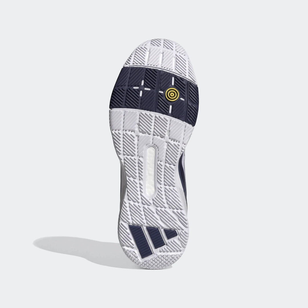 Top-down view of the sole of an Adidas Crazyquick Boost Padel shoe, featuring white, navy blue, and yellow textured grip