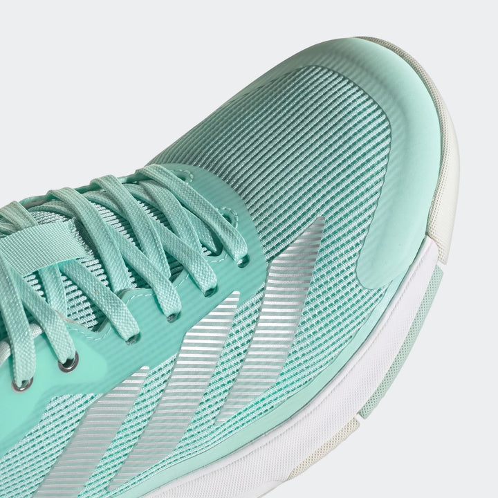 Close-up of a mint green Adidas Crazyquick Lightstrike Padel Shoe, showcasing its mesh upper, laces, and silver stripe