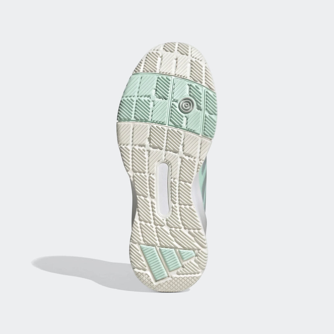 Bottom view of an Adidas Crazyquick Lightstrike Padel Shoe sole in mint green and off-white, featuring a detailed geometric