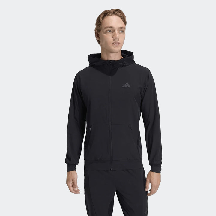Black Adidas D4T Hybrid Full-Zip Hoodie for men, shown on a male model from the front, featuring zippered pockets.