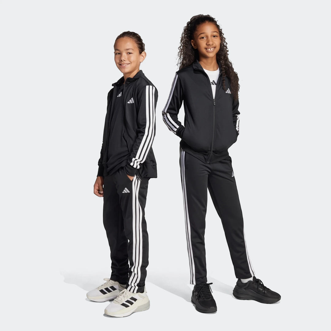 Two children in black Adidas Essentials Climacool Track Suits, featuring white three-stripes, standing full body.