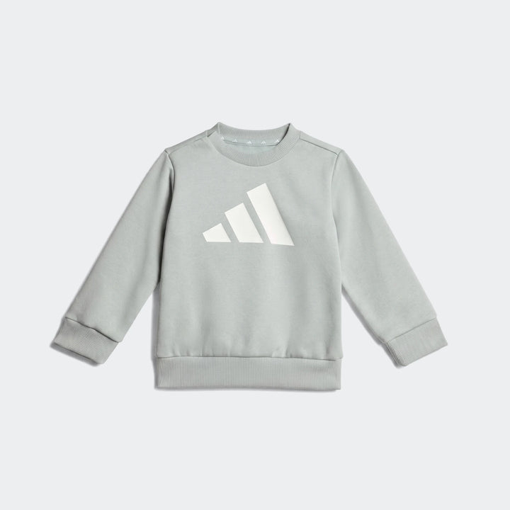 Light green Adidas Essentials Joggers Kids sweatshirt with a large white logo, flat lay view.