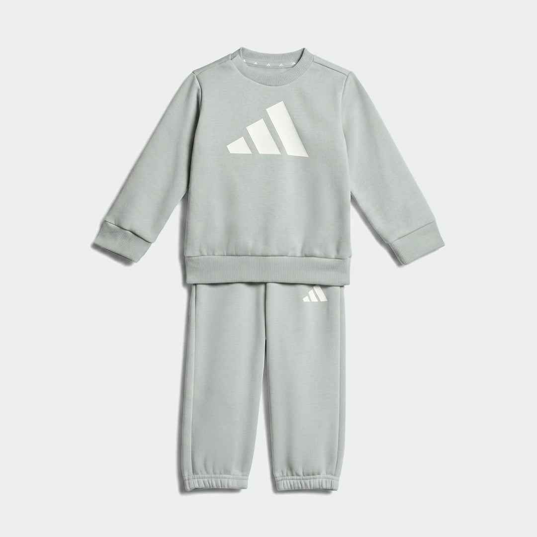 Light green Adidas Essentials Kids Joggers sweat set, featuring a long-sleeved sweatshirt and sweatpants, displayed flat.