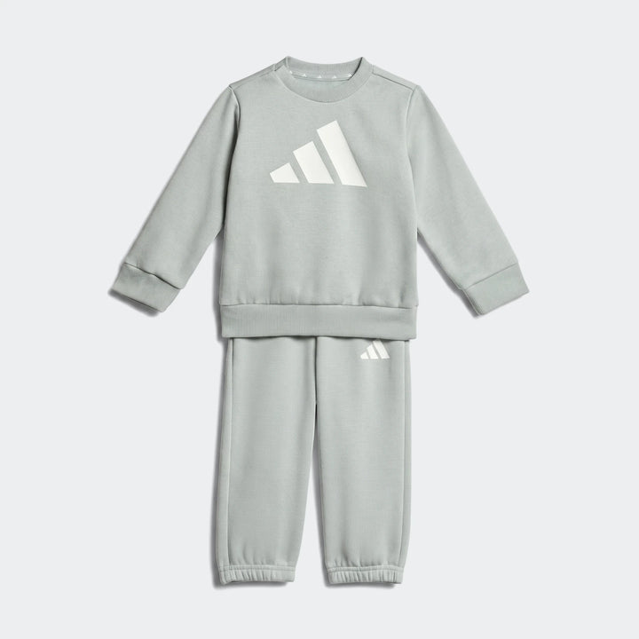 Light green Adidas Essentials Kids Joggers sweat set, featuring a long-sleeved sweatshirt and sweatpants, displayed flat.
