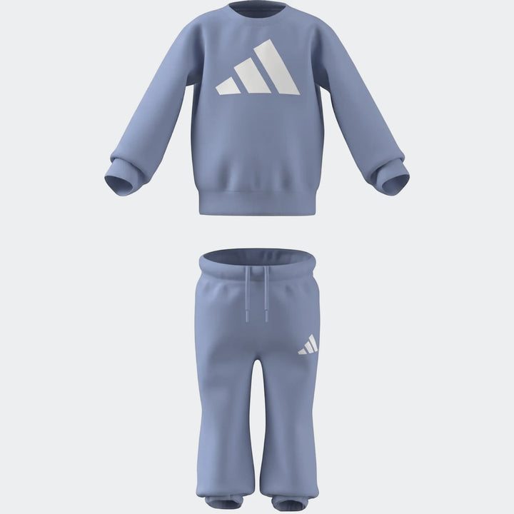 Light blue Adidas Essentials two-piece kids' tracksuit with a long-sleeve sweatshirt and joggers, featuring ribbed details.