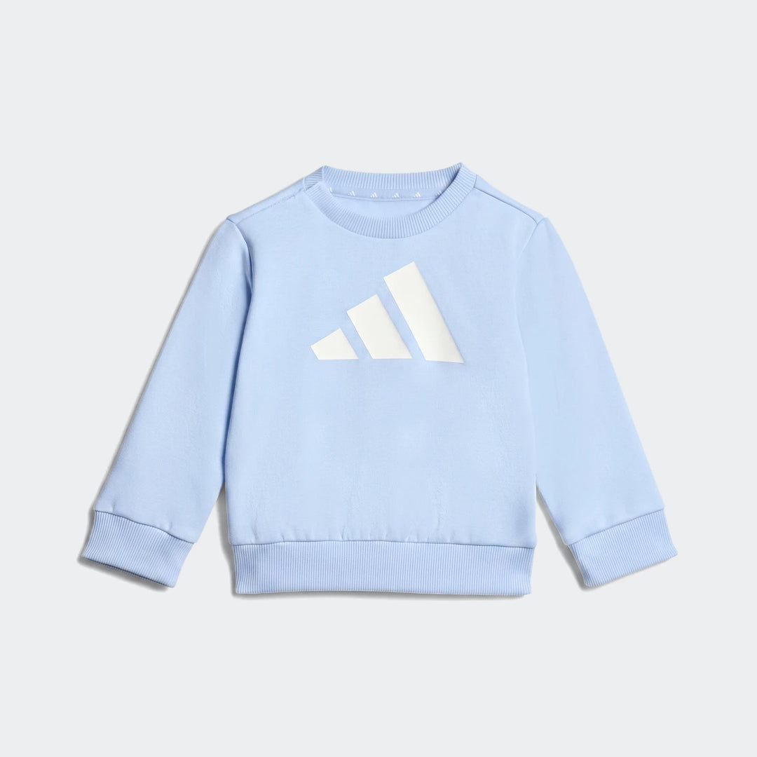 Light blue Adidas Essentials crewneck sweatshirt with white logo, featuring ribbed collar, cuffs, and hem, photographed on a