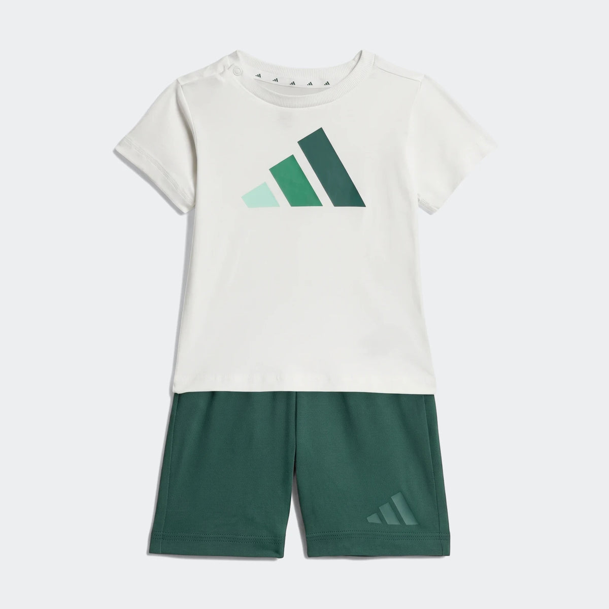 Adidas Kids Essentials Tee Set featuring a white short-sleeve t-shirt with a multi-green logo and dark green shorts.