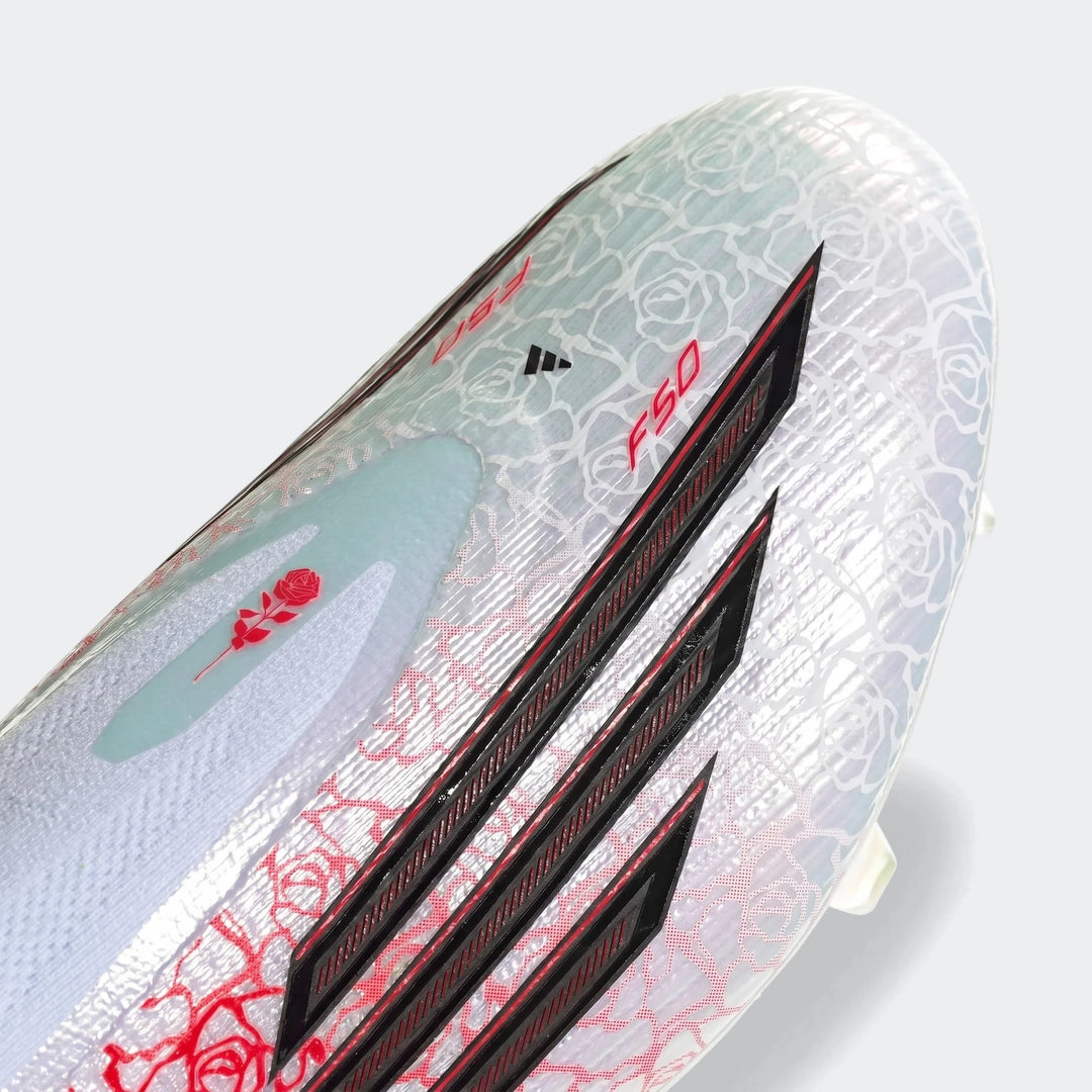 Close-up of white Adidas F50 Elite LL FG Lamine Yamal football boots featuring red rose patterns and black stripes.