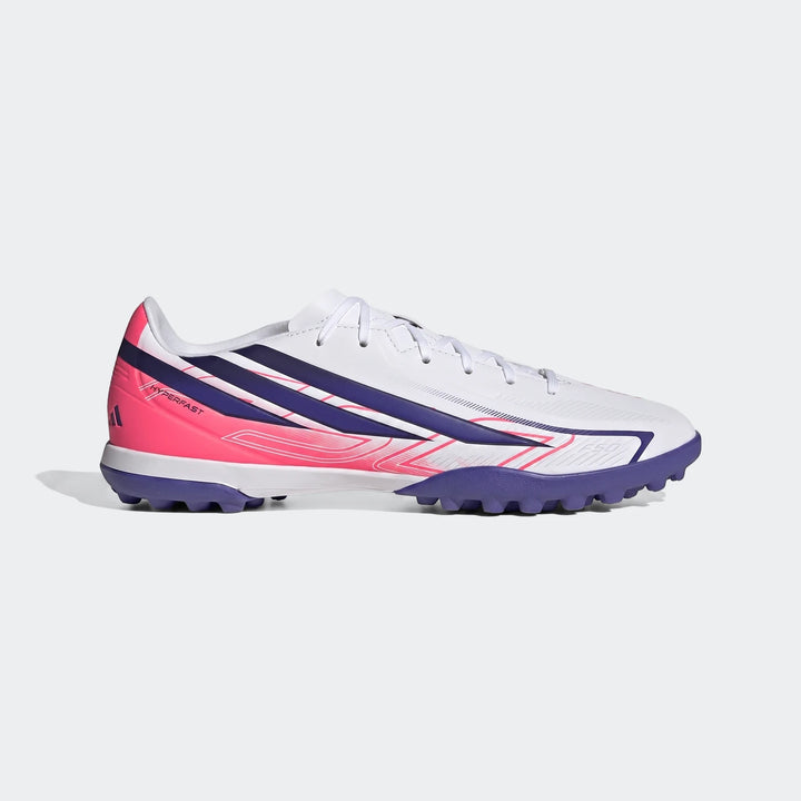 Adidas F50 Hyperfast Club Turf Football Shoes in white, pink, and purple, featuring a studded outsole, shown from a side