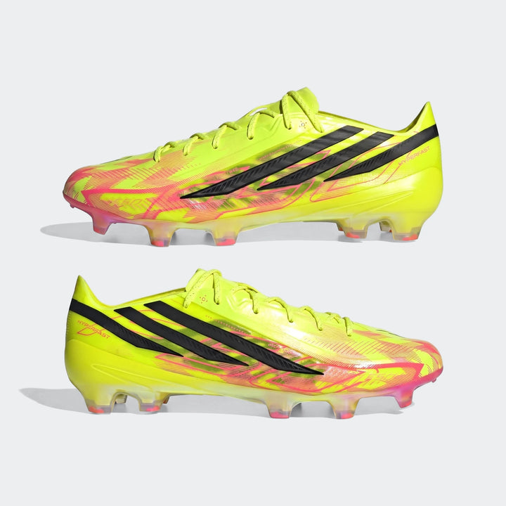 Pair of bright yellow and pink Adidas F50 Hyperfast Elite firm ground football boots with black stripes, shown from the side.