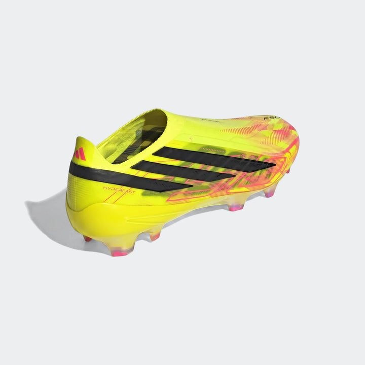 Yellow Adidas F50 Hyperfast Elite laceless firm ground boots with pink and black accents, side view.