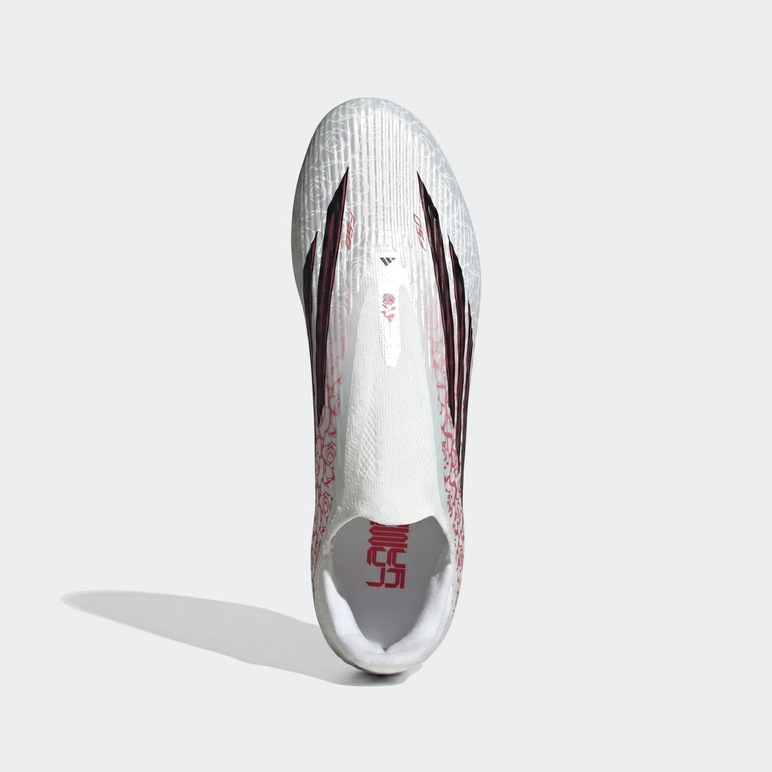 Top-down view of white Adidas F50 League Ll Fg / Mg Lamine Yamal football boots with red graphics and black stripes.