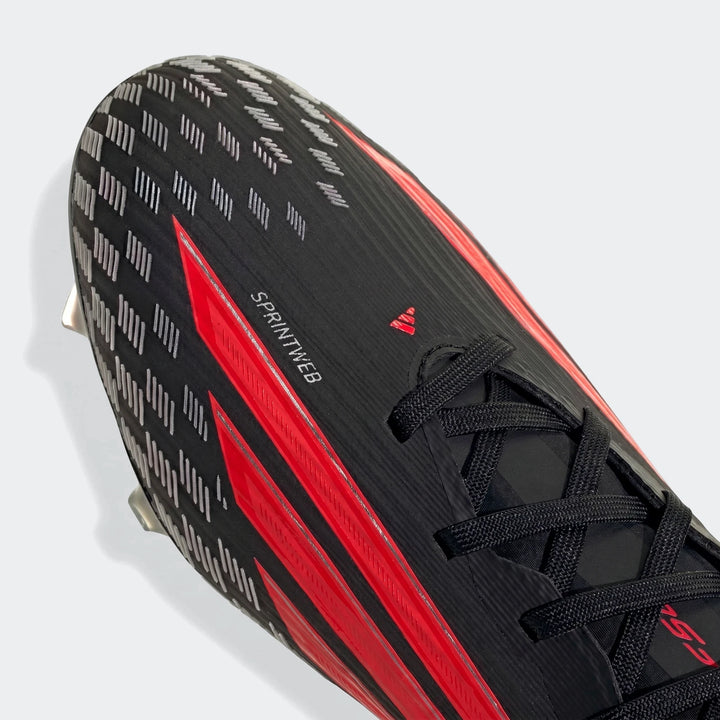 Black and red Adidas F50 Pro Firm Ground Football Boots, shown in an angled close-up highlighting the toe and laces.