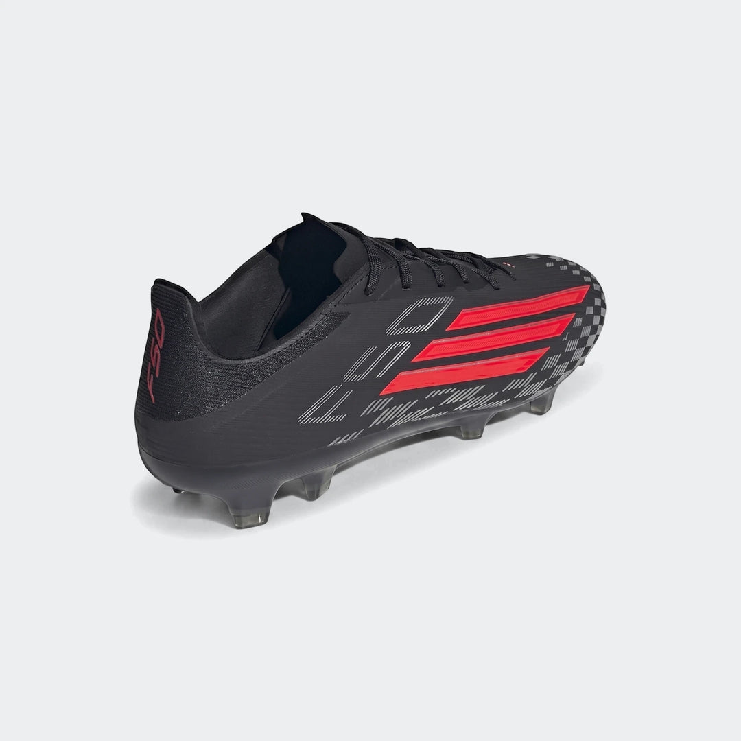 Black and red Adidas F50 Pro Firm Ground Football Boots with clear studs, presented in an angled view.