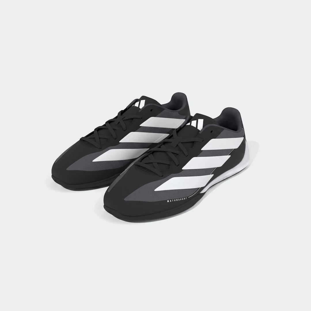 A pair of black and white Adidas Feroza Base Shoes for motorsport, featuring classic three stripes and a low-profile