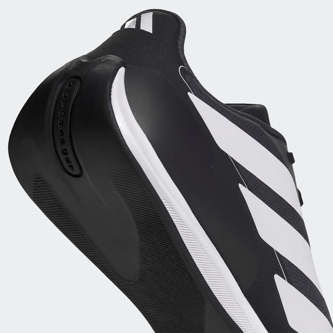 Adidas Feroza Base Shoes in black and white with signature stripes and a textured sole, captured from a side-rear angle.