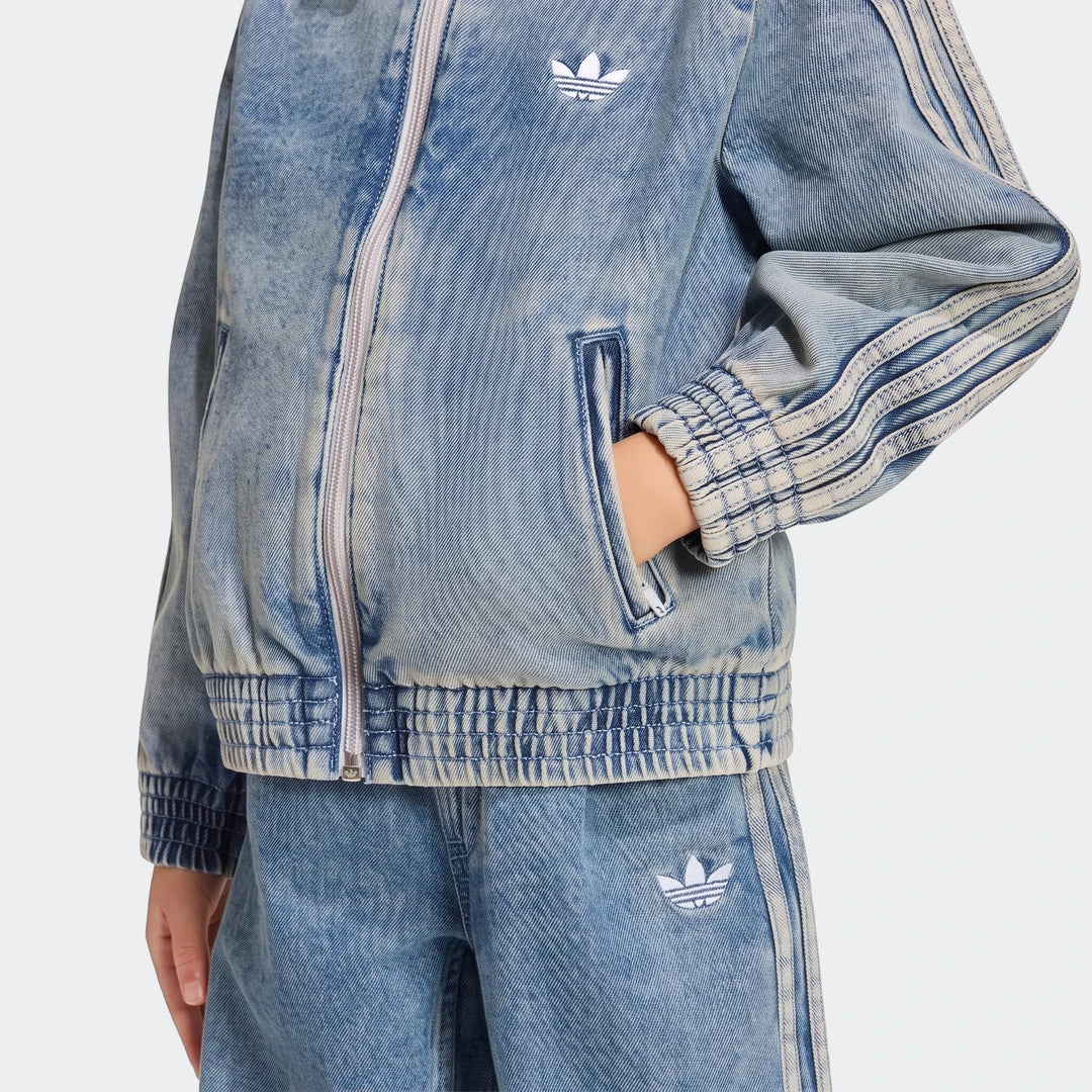 Adidas Firebird Loose Denim Track Top for women, shown in a light blue acid wash with classic three-stripes on sleeves and